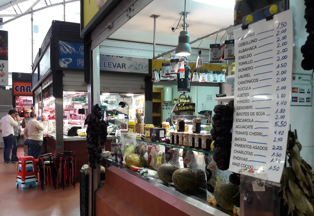 A produce stall inside a covered market.