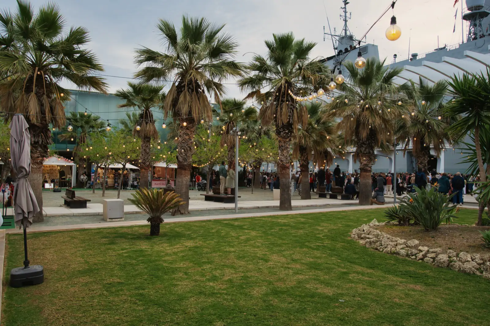 Evening fair stalls lit up in Malaga province with string lights in the garden