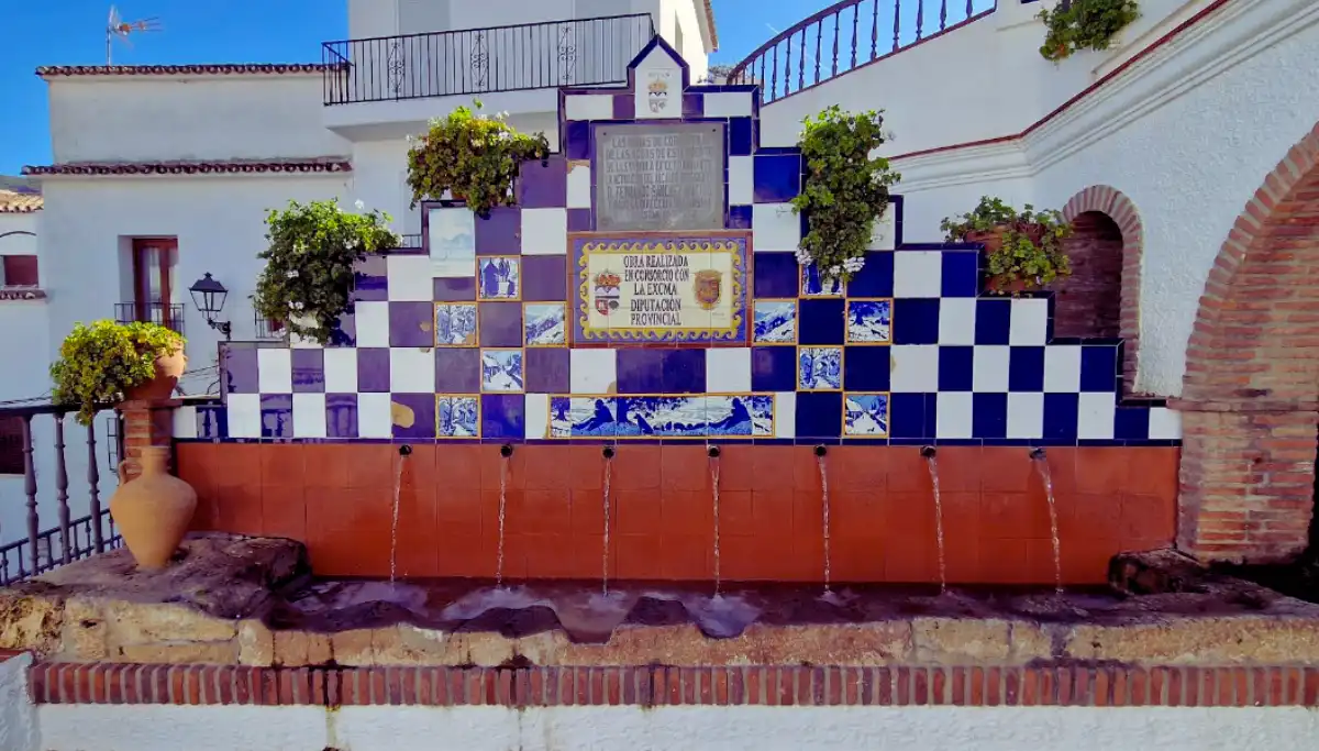 The whitewashed village of Istan with a stone fountain in the foreground