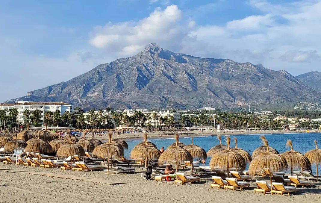 Puerto Banús beach with the marina, superyachts and beach clubs behind