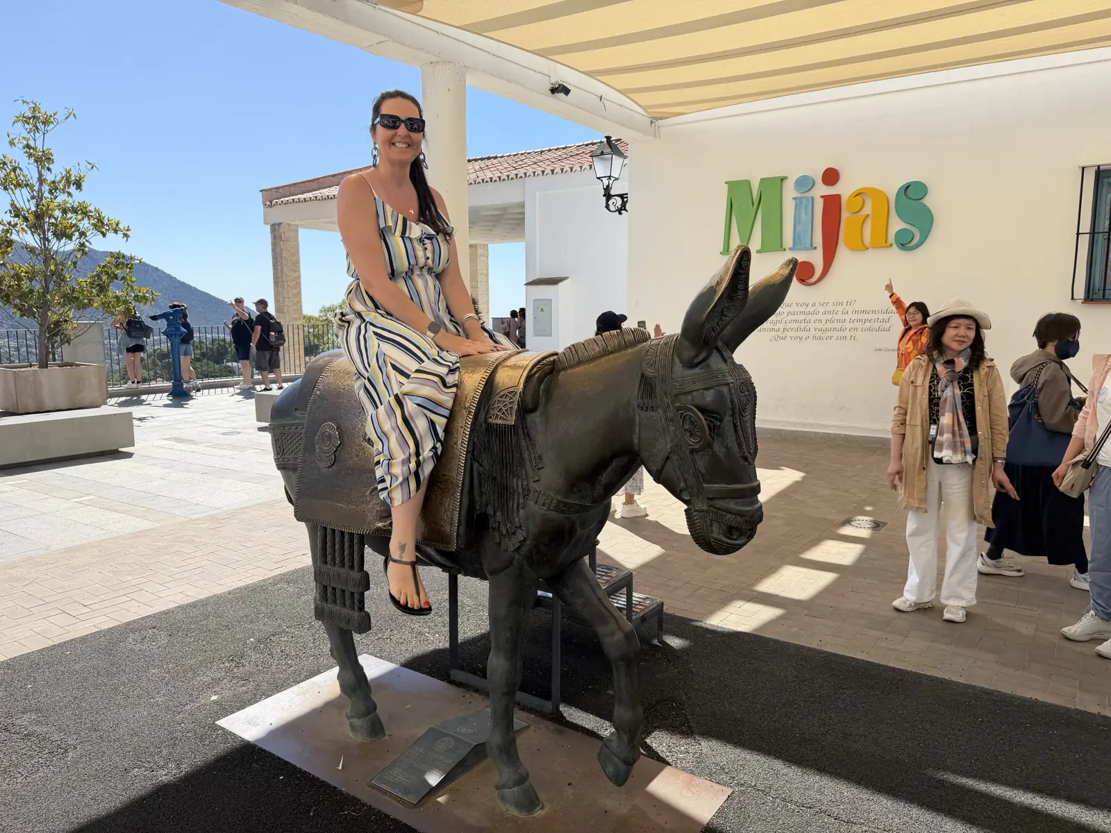 Heidi sitting on the bronze donkey statue in Mijas Pueblo