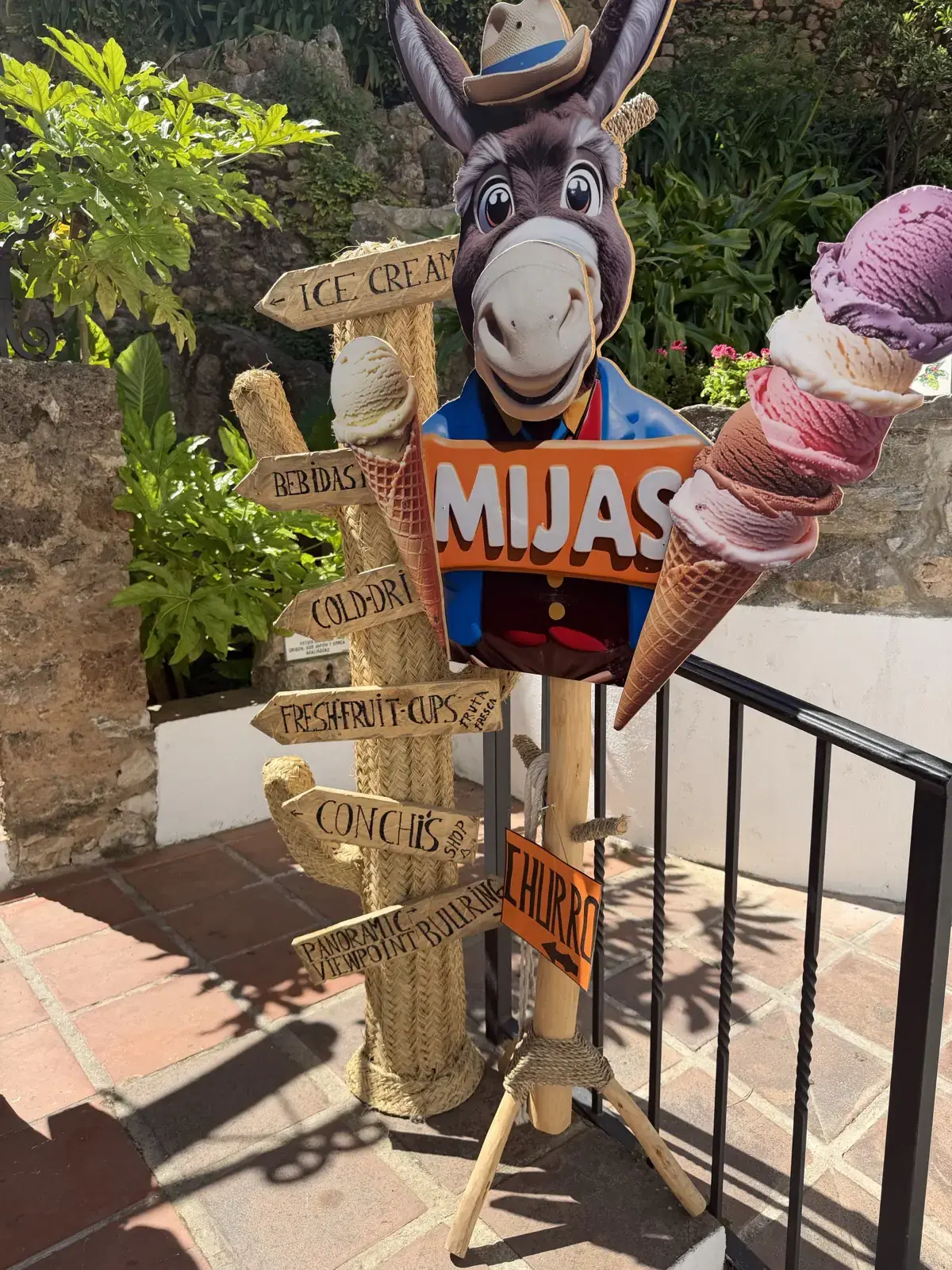 The Mijas sign on the approach road with a small painted donkey