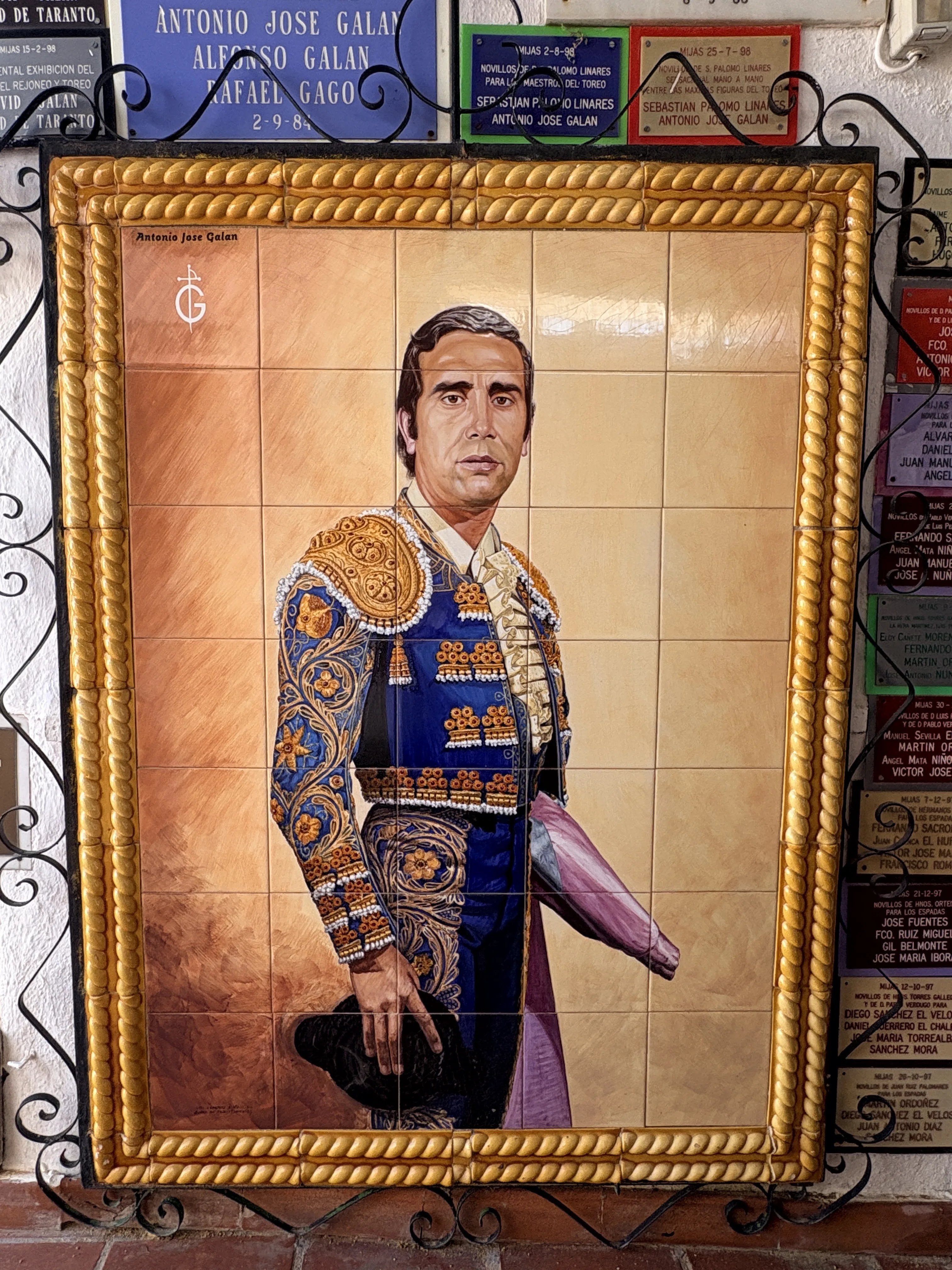 Ceramic tile portrait of a matador in an ornate gold frame