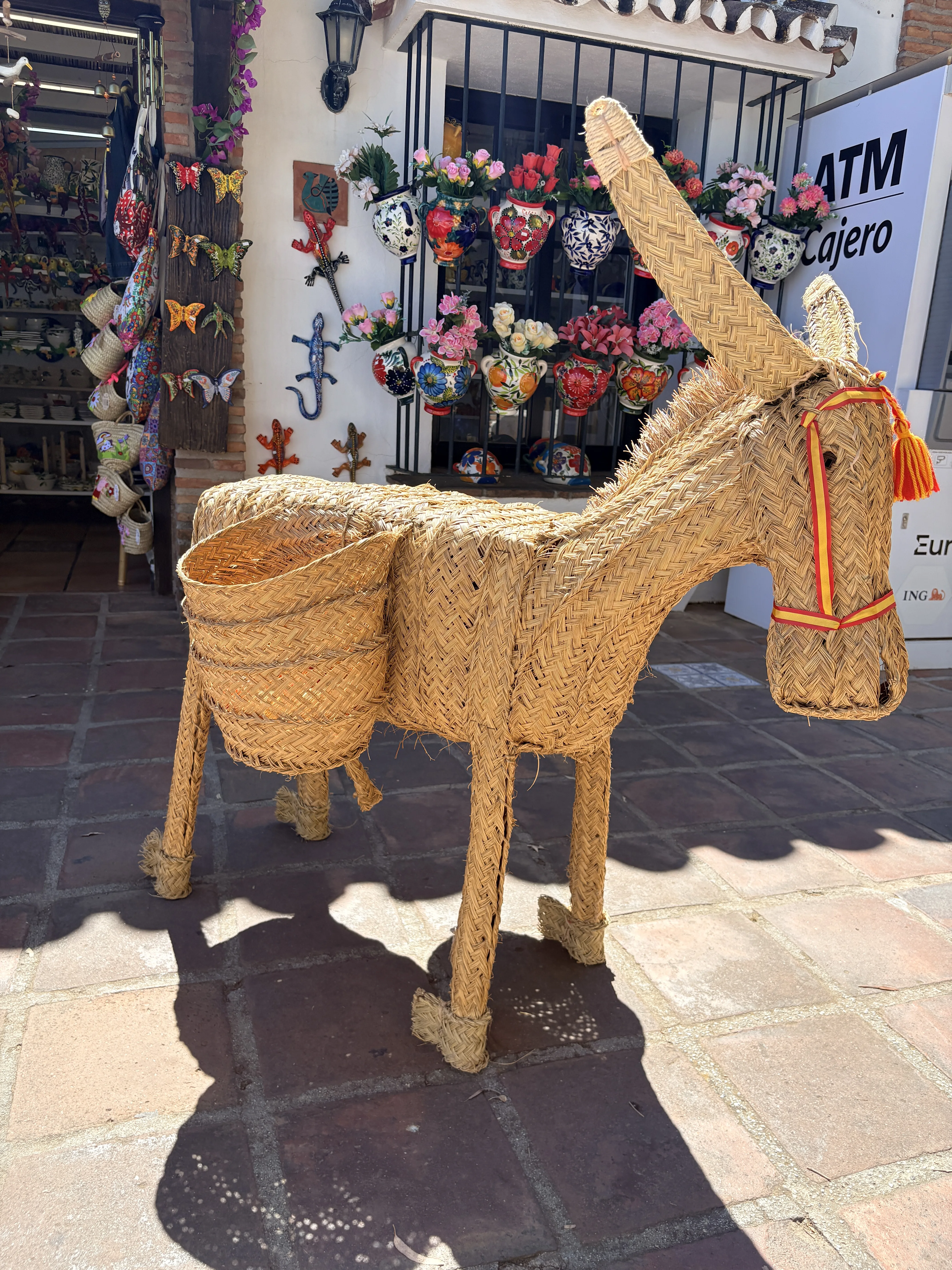 Wicker donkey sculpture outside a souvenir shop in Mijas