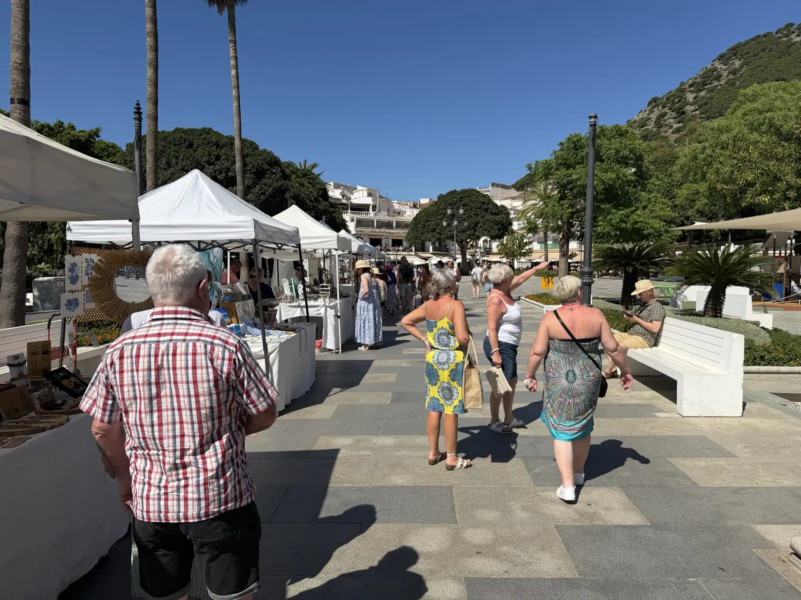 The Mijas Pueblo market with the village and mountains in the background