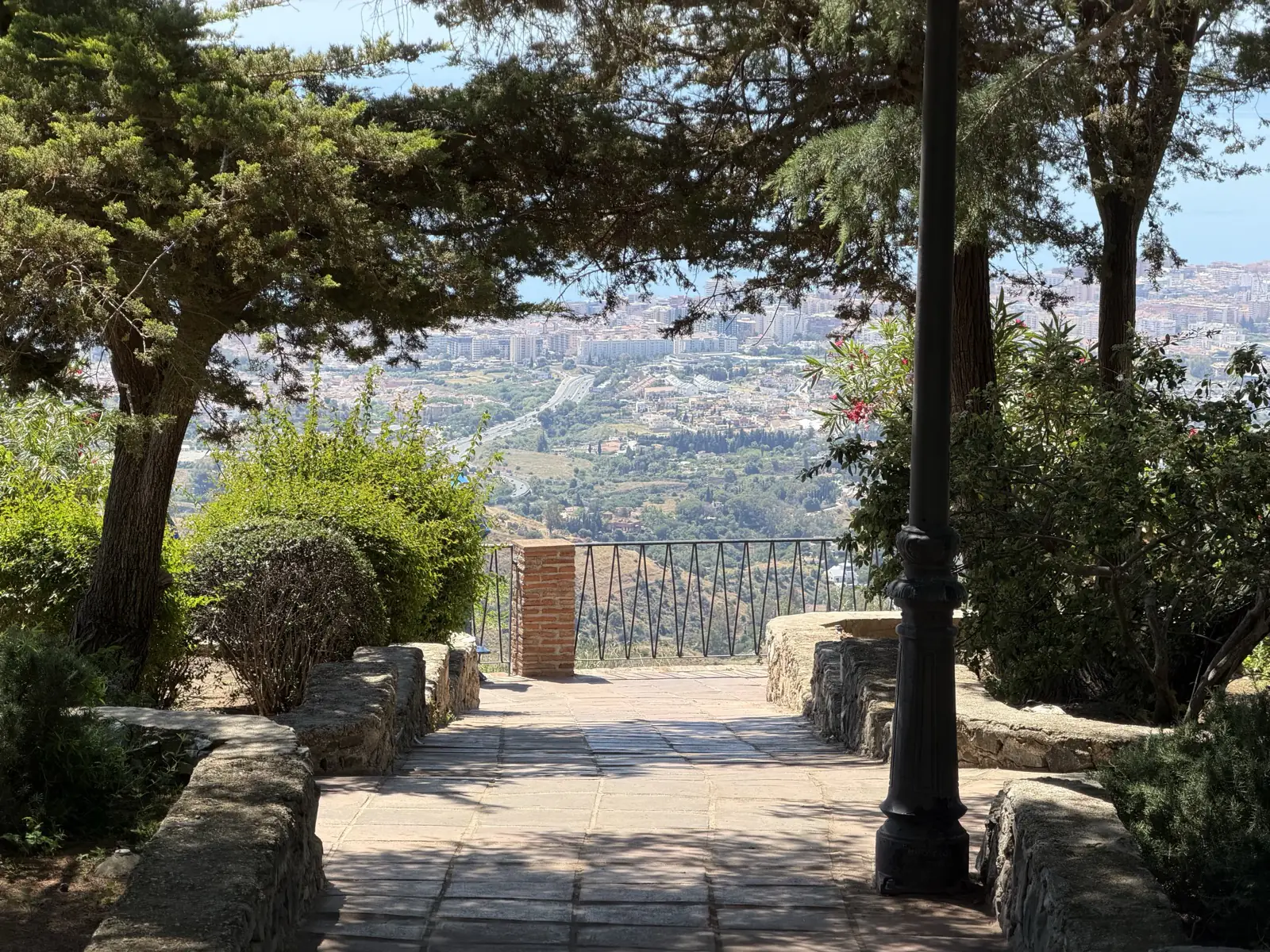Wide view of the Paseo de la Muralla gardens in Mijas Pueblo with the coast below