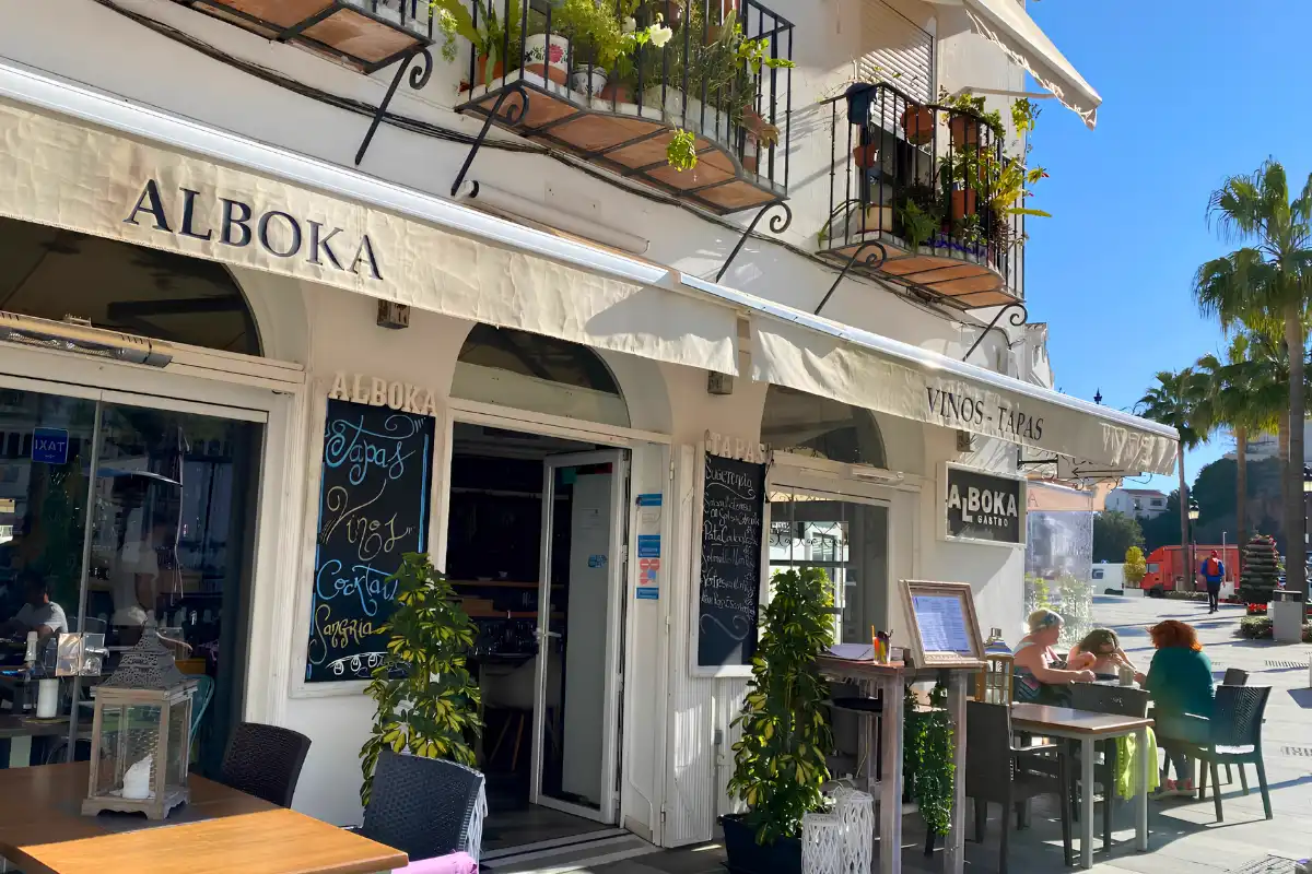 The exterior of Alboka Gastrobar in Mijas Pueblo with Vinos Tapas awning and outdoor tables