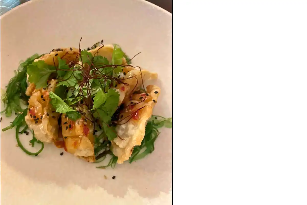 A crispy fish tapa with fresh greens and sesame seeds at a restaurant in Mijas Pueblo
