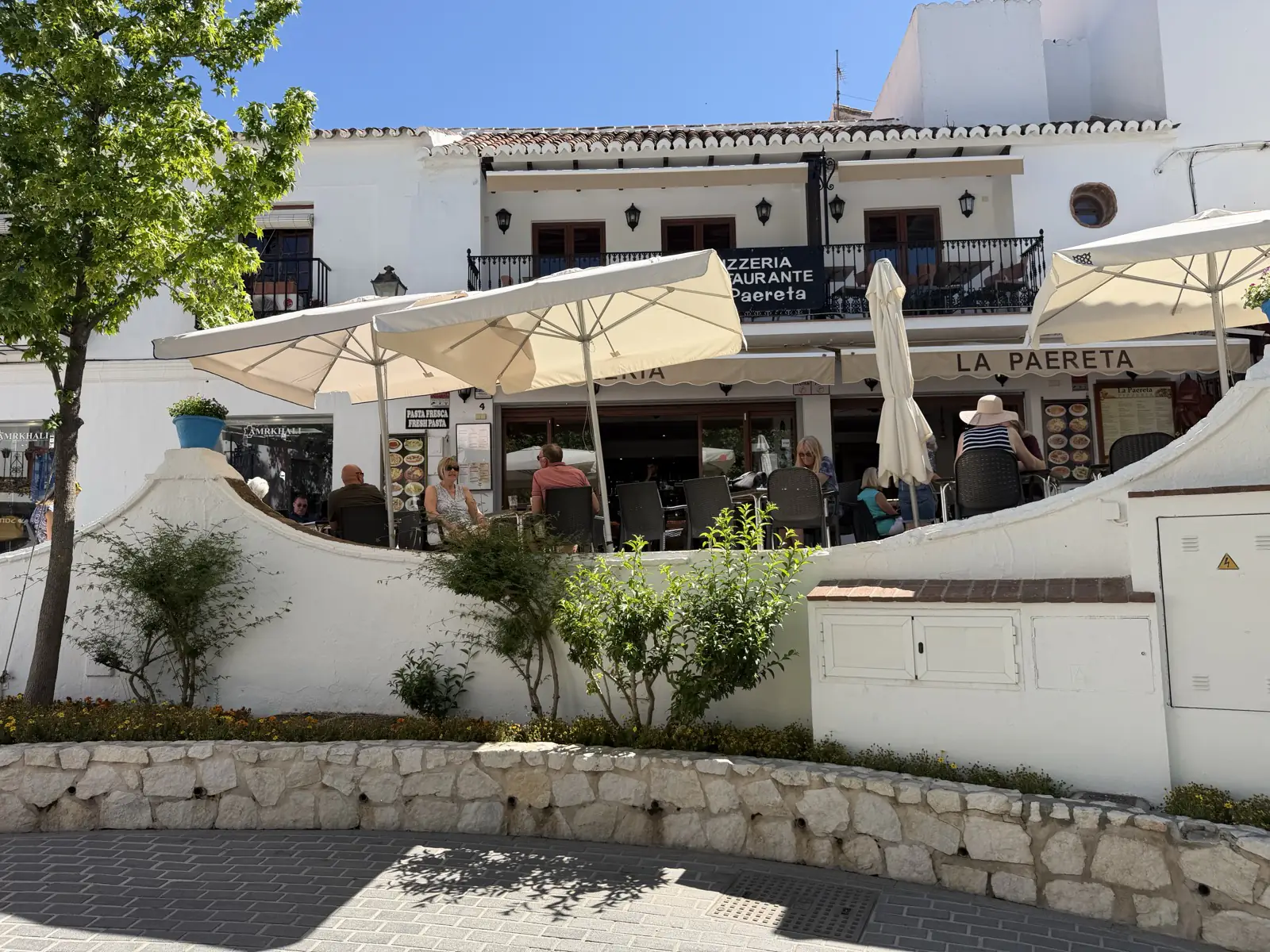 People eating at a restaurant on Plaza de la Constitución with views below