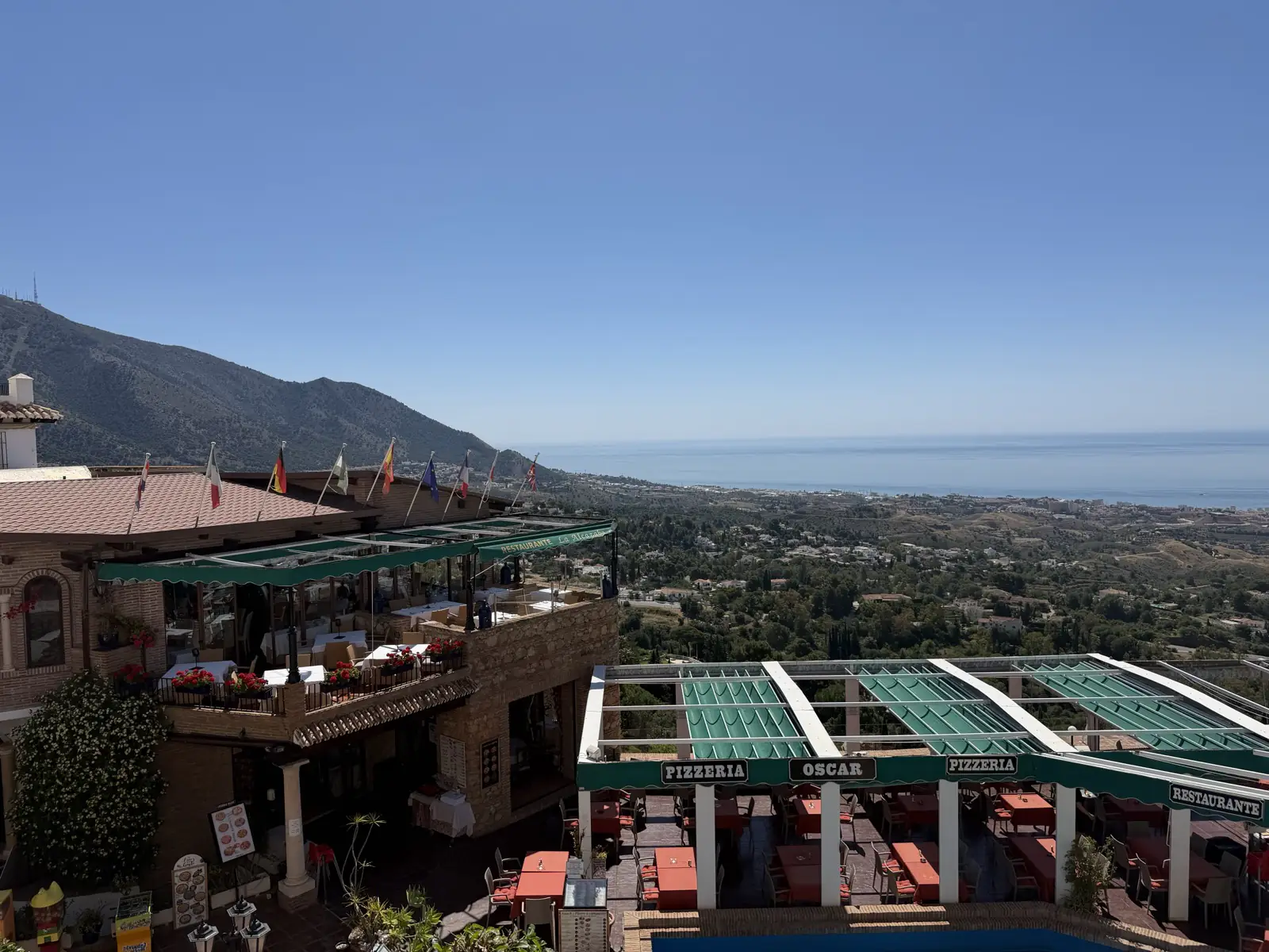 Restaurant terrace in Mijas Pueblo with coastal views.