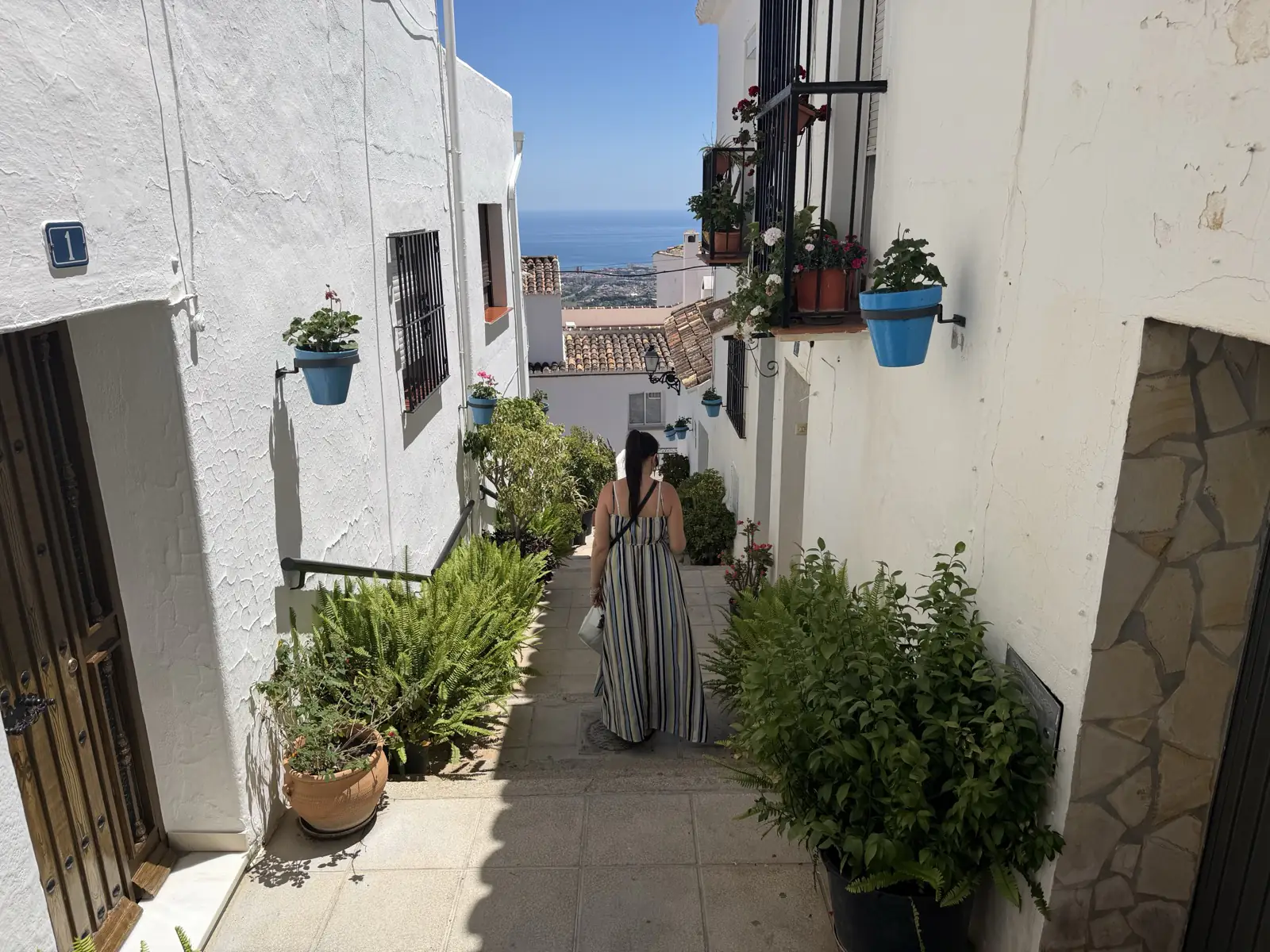 Walking down toward the sea view at the end of a street in Mijas Pueblo