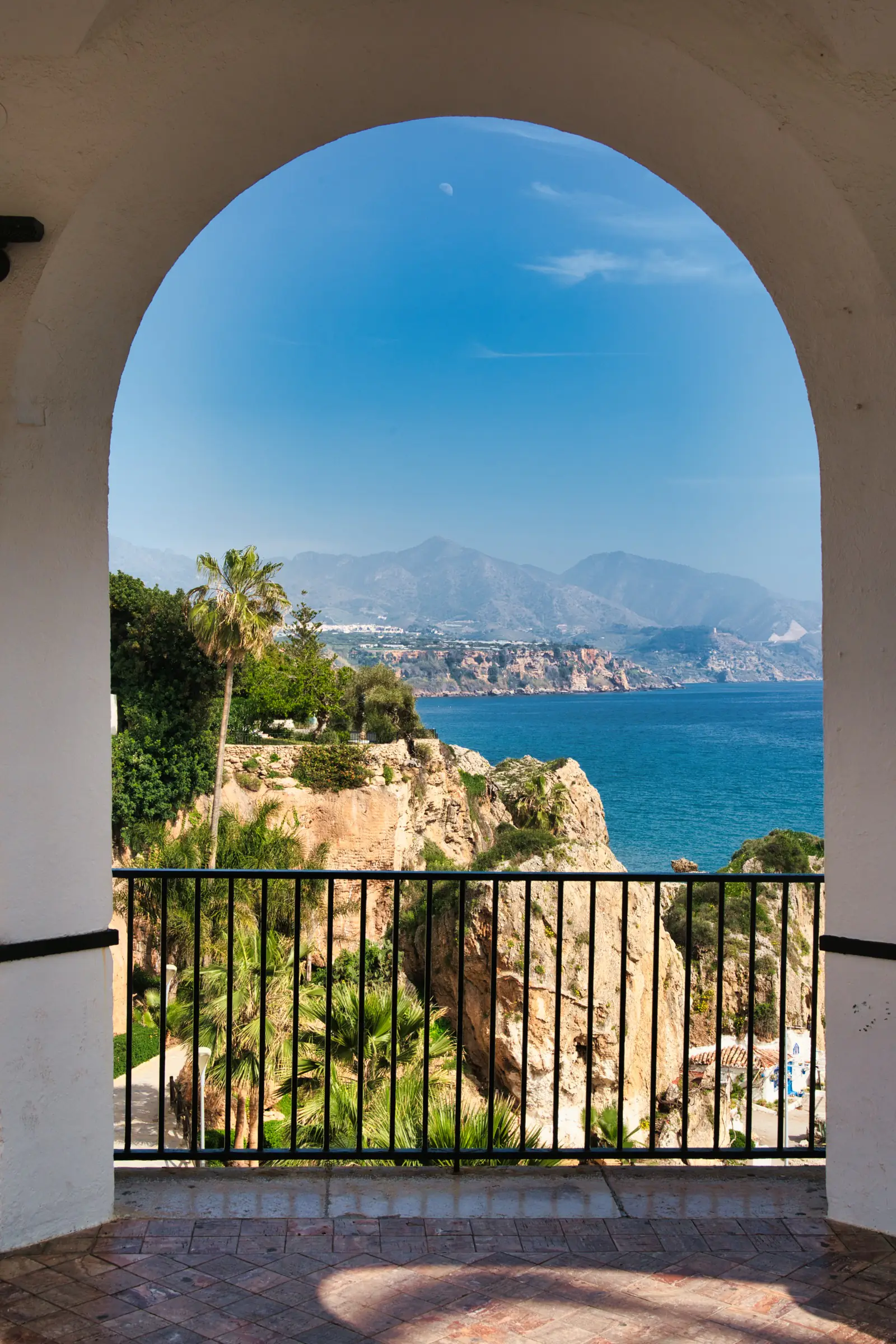 Beach in Nerja seen through pillars.