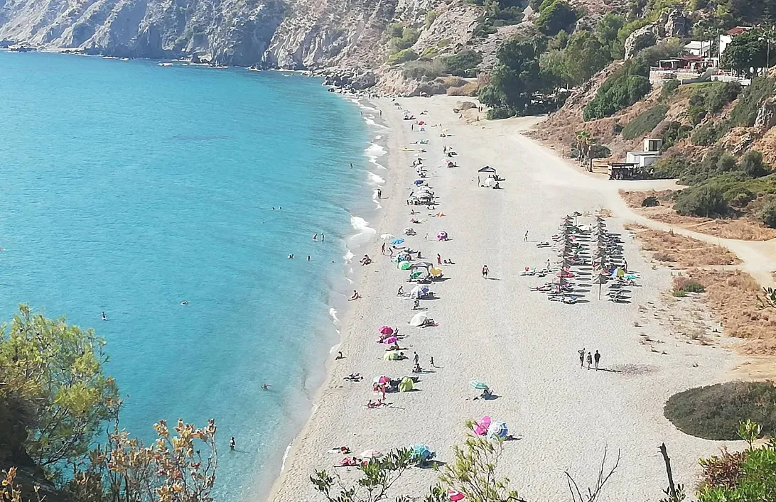 Secluded Cala del Cañuelo cove near Maro with clear blue water and rocky cliffs