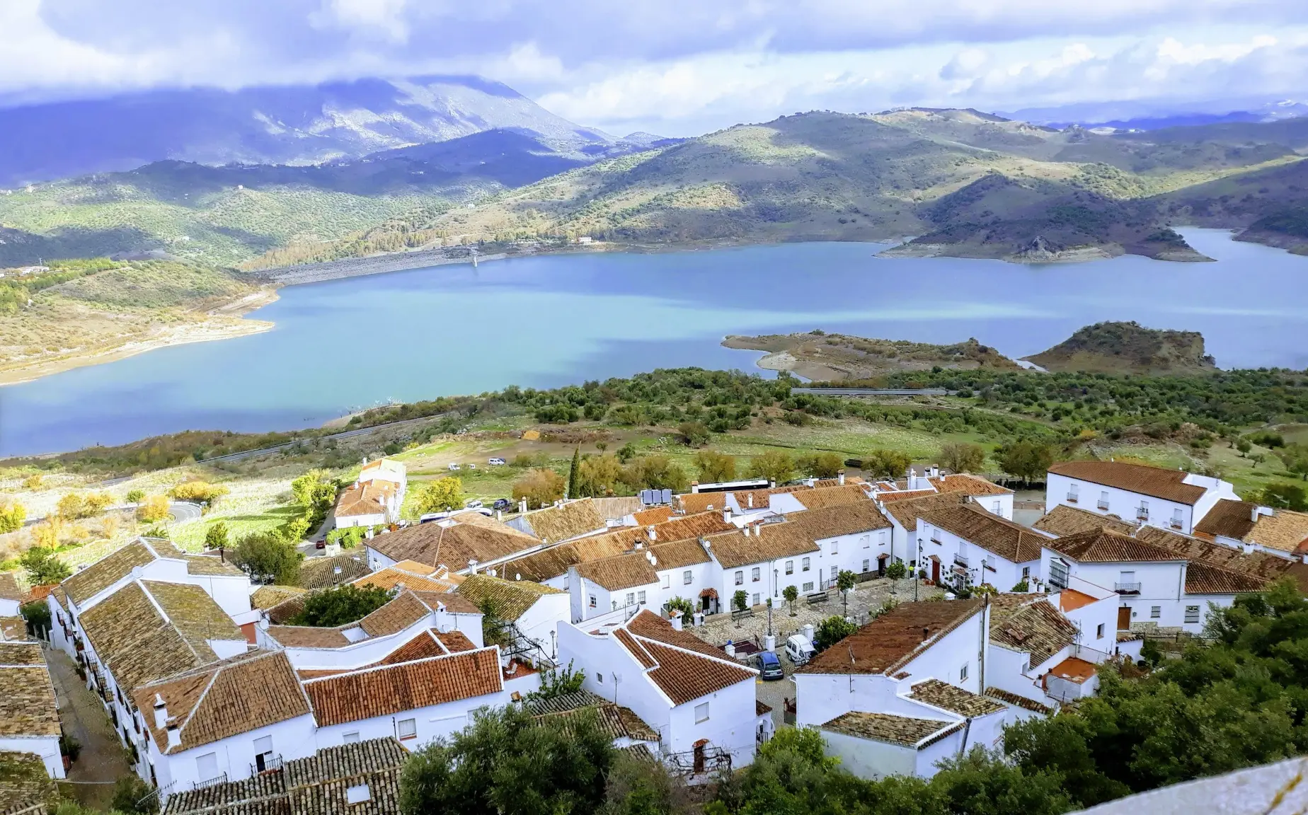 A village on a mountain with a lake.