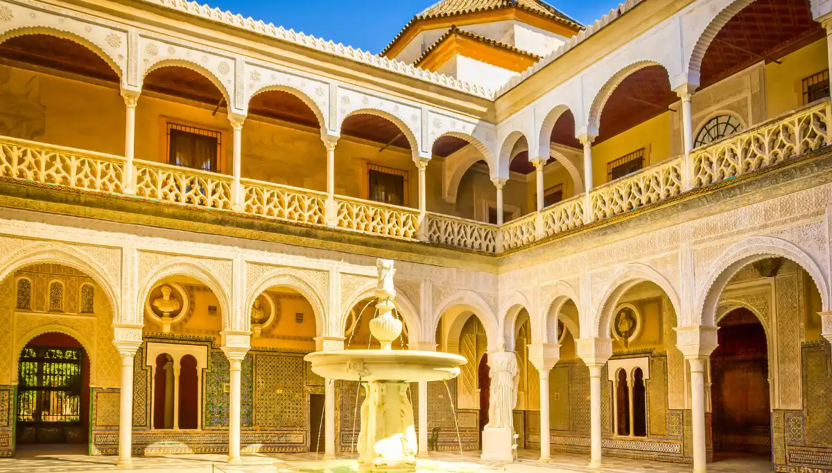 Courtyard with fountain and Mudejar arches inside Casa de Pilatos in Seville