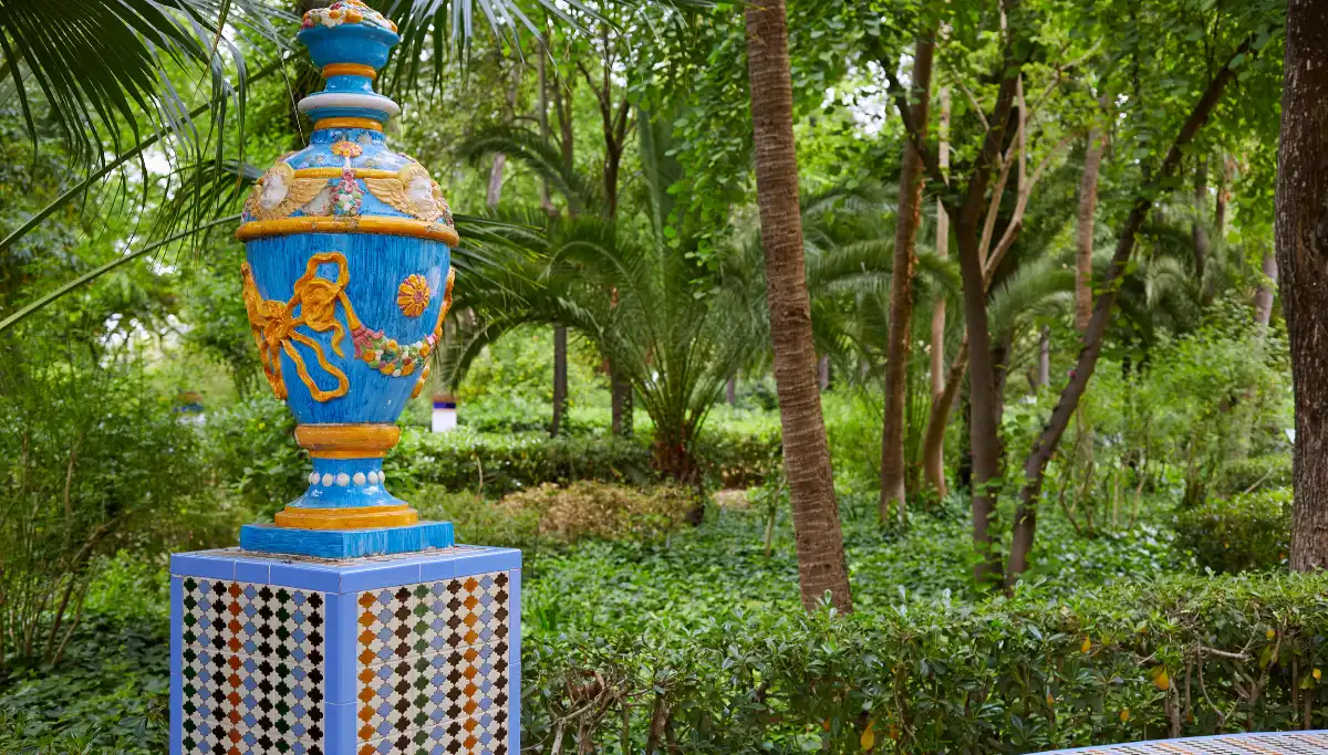 Colourful ceramic vase surrounded by palm trees and greenery in Maria Luisa Park