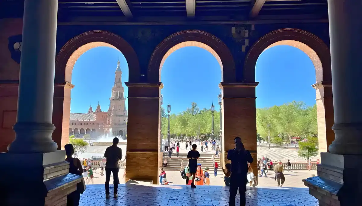 Plaza de Espana seen through shaded arches in Seville