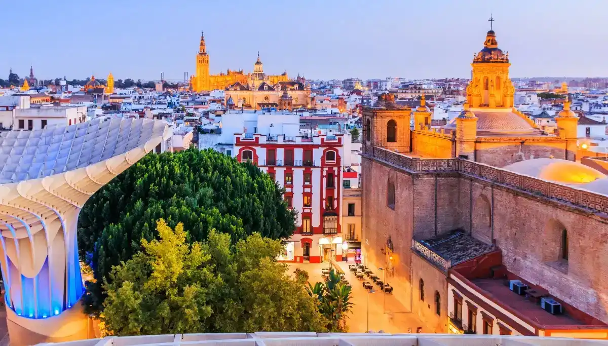 Rooftop view of Seville skyline at dusk with the Giralda and Metropol Parasol
