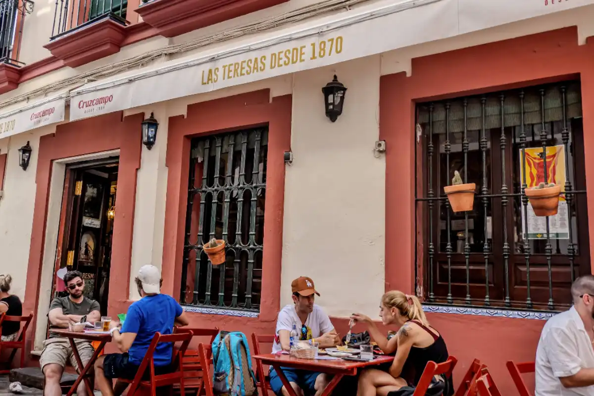 Cafe Bar Las Teresas in Seville's Santa Cruz, with hams hanging from the ceiling.